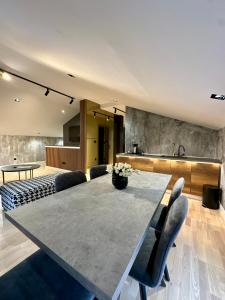 a kitchen and dining room with a table and chairs at Plaza Apartments in Sarajevo