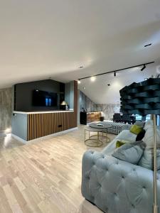 a living room with a couch and a table at Plaza Apartments in Sarajevo