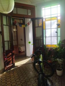 a bike parked in a room with a door open at Casa Buda in La Plata