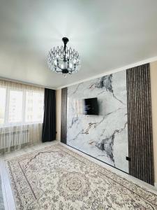 a room with a marble wall with a chandelier at Airport- Golden city in Almaty +10 photos