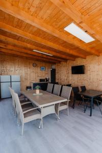 a dining room with a table and chairs at CAVO VILLAGE- Cabins Rental Băile 1 Mai in Rontău