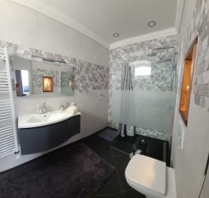 a bathroom with a sink and a toilet at Apartmenthaus am See - Seeblick Suite - Nähe Motorsportarena in Seehausen
