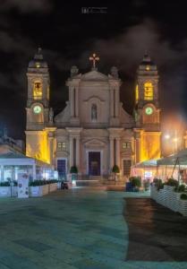 ein großes Gebäude mit zwei Uhrturm in der Nacht in der Unterkunft ..A DUE PASSI DAL MARE in Terrasini