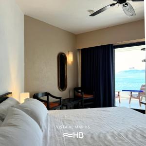 a bedroom with a bed with a view of the ocean at Hotel Barra de Navidad in Barra de Navidad