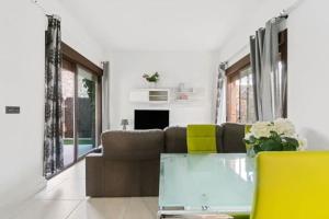 a living room with a couch and a glass table at VillaHeLena in Orihuela Costa