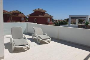 two chairs sitting on top of a roof at VillaHeLena in Orihuela Costa