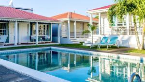 una piscina di fronte a una casa di Talk of the Town Inn & Suites - St Eustatius a Oranjestad