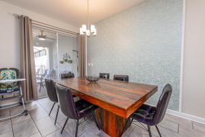 a dining room with a wooden table and chairs at MVP-4967WA SL townhouse in Kissimmee