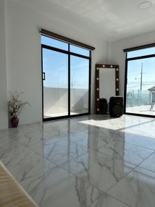 a living room with a marble floor and large windows at Villasrock2022 in San Clemente