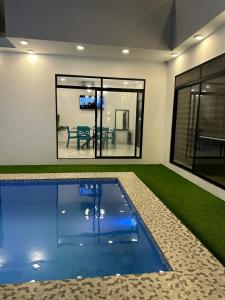 a swimming pool in a house with a dining room at Villasrock2022 in San Clemente