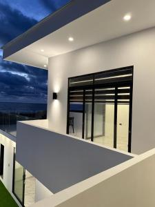 a house with a balcony with a view of the ocean at Villasrock2022 in San Clemente