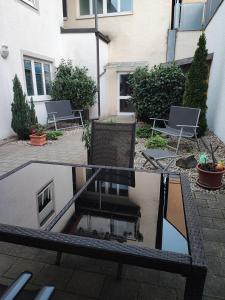 a reflection of a table and chairs in a courtyard at FeWo Planer Altstadtwohnung mit Terrasse & Parkplatz in Memmingen +28 photos