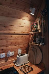 a small kitchen with a toaster on a wooden counter at Sea View Pod Close to Mountains / Snowdonia in Caernarfon +27 photos