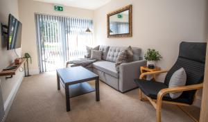 a living room with a couch and a table at Spacious APT Romantic Getaway in Eastbourne