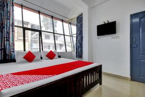 Ένα ή περισσότερα κρεβάτια σε δωμάτιο στο Munnar Rest & Lodging