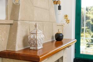 a table with a vase and an apple on it at Villa Giannari in Stalos +64 photos