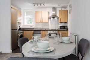 a kitchen with a table with plates and bowls on it at Stylish 2 bed flat/Liverpool city/Free parking in Liverpool