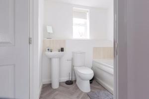 a white bathroom with a toilet and a sink at Stylish 2 bed flat/Liverpool city/Free parking in Liverpool