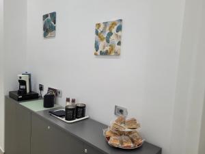 a counter with a pile of pastries on it at Gemini rooms in Crotone