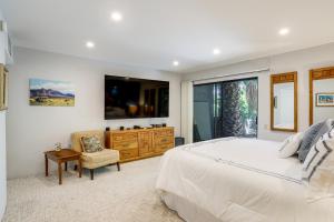 a bedroom with a large bed and a large window at Palm Springs Condo 3 Fenced Patios, Pool Access in Palm Springs +20 photos