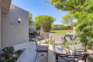 a patio with two chairs and a table and chairs at Palm Springs Condo 3 Fenced Patios, Pool Access in Palm Springs