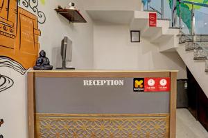 a reception desk in a room with a staircase at Super OYO Madpackers Khajuraho in Khajurāho