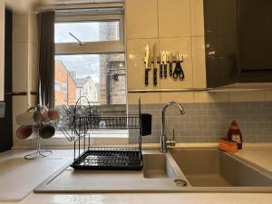 a kitchen counter with a sink and a window at 4 Bedroom Anfield House, 7 beds, Free Parking, Garden - 5 mins to LFC, 15 mins to City Centre in Liverpool