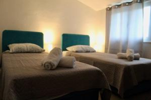 a room with two beds with towels on them at Apartman Oliva in Posedarje