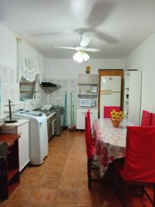ノヴォ・アンブルゴにあるApartamento das Azaléias térreoのキッチン(テーブル、天井ファン付)