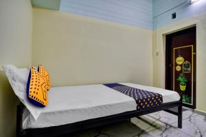 a bedroom with a bed with a butterfly pillow on it at Hotel Revathy Tourist Home in Kollam