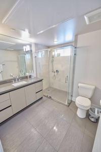 a bathroom with a shower and a toilet and a sink at $3M Penthouse in K-Town with Private Roof Deck in Los Angeles