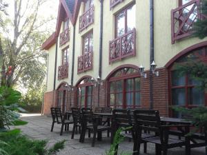 a group of tables and chairs in front of a building at Bed Breakfast Hotel Budapest in Budapest