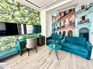 a living room with a couch and a tv at Hotel Del Medio in Sutomore
