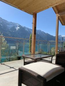 a patio with a table and a view of the mountains at lina in Niederried