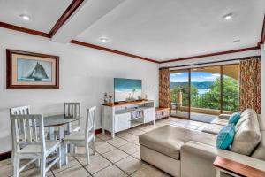 a living room with a couch and a table at Newly remodeled unit in Flamingo with sweeping ocean views from big terrace in Playa Flamingo