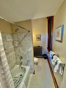 a bathroom with a shower and a tub and a toilet at Cripple Creek Hospitality House in Cripple Creek +82 photos