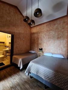 a bedroom with two beds and a sink in it at Central Hostel Boutique in Antigua Guatemala