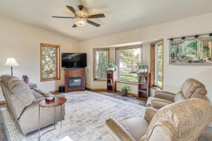 a living room with a couch and a fireplace at Scenic and Serene Rapid City Getaway on 1 half Acres! in Rapid City