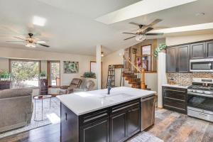 a kitchen with a sink and a living room at Scenic and Serene Rapid City Getaway on 1 half Acres! in Rapid City