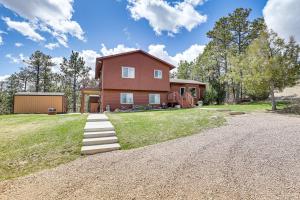 a house with a gravel driveway in front of it at Scenic and Serene Rapid City Getaway on 1 half Acres! in Rapid City
