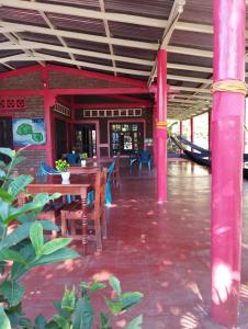 a restaurant with a table and chairs and a boat at El Güis hostel in Balgue