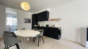 a kitchen and dining room with a white table and chairs at ApartmentInCopenhagen Apartment 1608 in Copenhagen