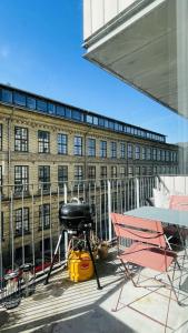 a table and chairs on a balcony with a building at ApartmentInCopenhagen Apartment 1608 in Copenhagen