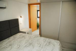 a bedroom with a bed and a sliding glass door at Oporto Cruz - Douro Valley in Baião