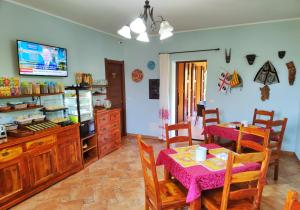a kitchen with a table and a dining room at Nuraghe Bianco in Santa Maria la Palma