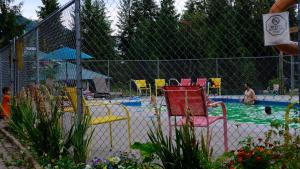 a pool with chairs and people in the water at Clearwater Valley Resort in Clearwater