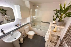 a bathroom with a sink toilet and a shower at Trendy 1BD Penthouse wCity Views Hackney Wick in London