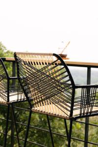 a wicker chair sitting at a table on a balcony at Glamping MontdeLuxe in Yopal