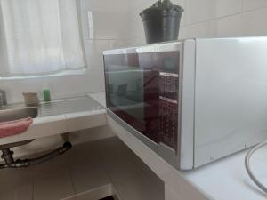 eine Mikrowelle auf einer Theke in einer Küche in der Unterkunft Posada Santa Elena (1 cama) in Santa María Atlihuetzián