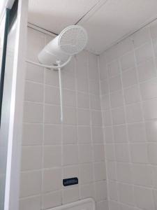 a bathroom with a shower with a ceiling fan at flat Allianz Parque com estacionamento in São Paulo